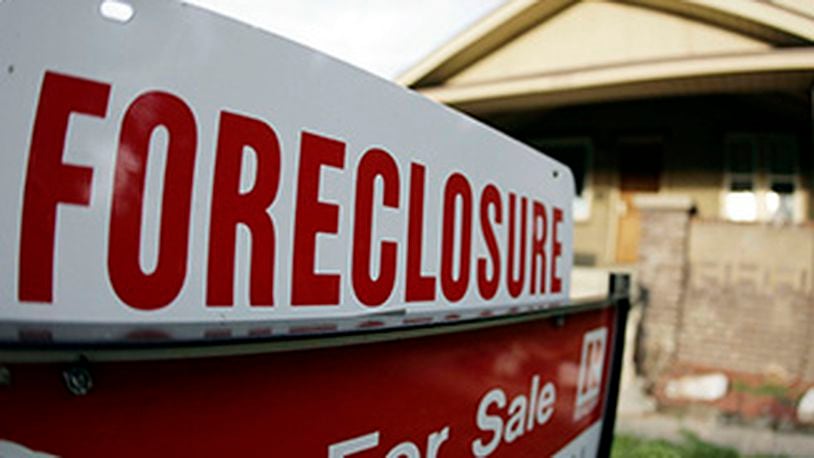 Foreclosures are slowing to such an extent banks are now seizing the homes of people who pay their bills on time. (AP photo from unrelated story)