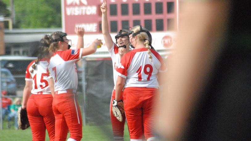 Members of the Fairfield High School softball team celebrate at the pitcher's circle in between innings against Harrison in the district semifinals. The Indians beat Centerville on Thursday to win a district title. Chris Vogt/CONTRIBUTED
