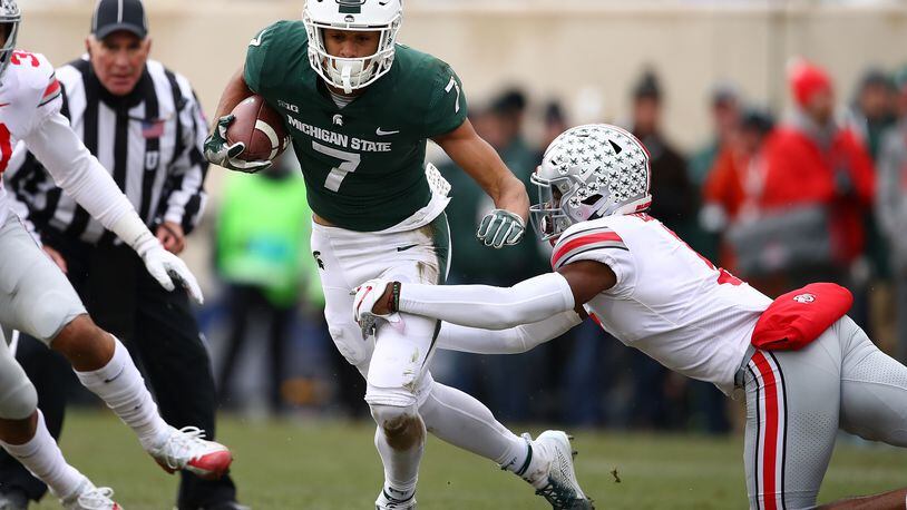 EAST LANSING, MI - NOVEMBER 10: Cody White #7 of the Michigan State Spartans tries to get around the tackle of Jeffrey Okudah #1 of the Ohio State Buckeyes after a first half catch at Spartan Stadium on November 10, 2018 in East Lansing, Michigan. (Photo by Gregory Shamus/Getty Images)