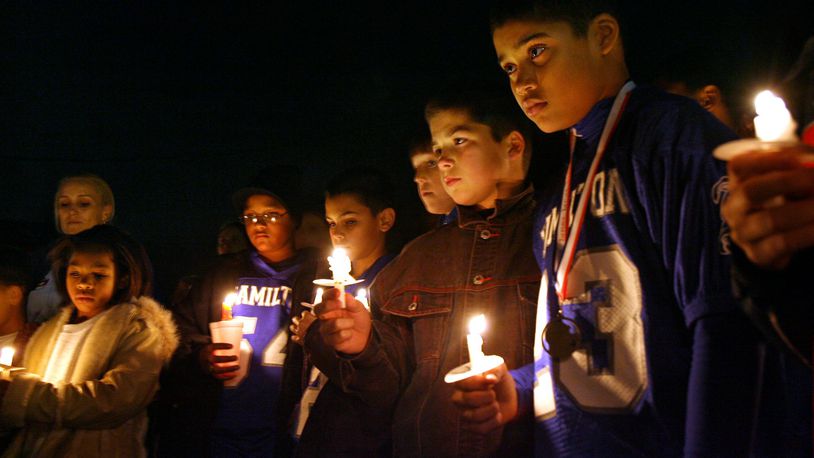 Members of Hamilton’s sixth-grade Little Blue football team gathered Monday Dec 12, 2007, outside the home of teammate DeMarcus Thomas, who was killed in a fire there earlier that morning. More than a 100 others were present to pay their respects. STAFF/NICK DAGGY