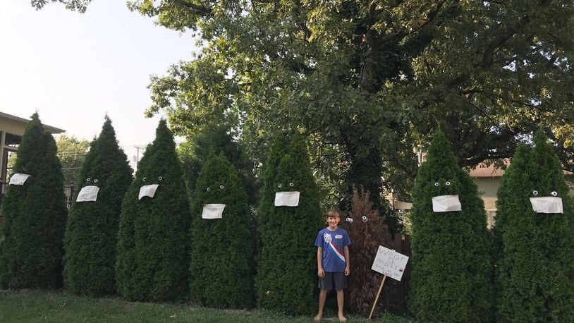 Tony Fomin, fifth-grader at William Bruce Elementary School, stands with his art instillation in front of his Eaton home. CONTRIBUTED