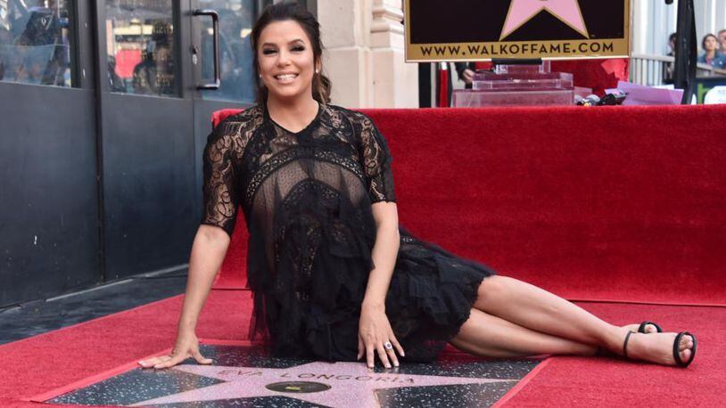 Eva Longoria poses with her star on the Hollywood Walk of Fame.