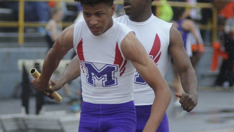 Middletown’s Marquise Petty (right) hands off to teammate Will Thomas in the 800-meter relay during the Division I district track & field meet at Dayton’s Welcome Stadium last May. MARC PENDLETON/STAFF
