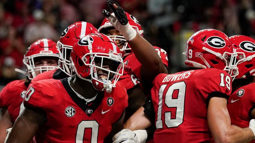 Georgia tight end Darnell Washington (0) celebrates after scoring a touchdown in the first half of the Southeastern Conference championship NCAA college football game, Saturday, Dec. 3, 2022, in Atlanta. (AP Photo/Brynn Anderson)