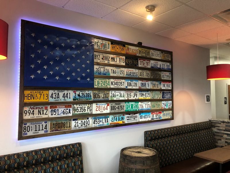 The owners of Prime BBQ Smokehouse in Monroe used state license plates to form an American flag. RICK McCRABB/STAFF