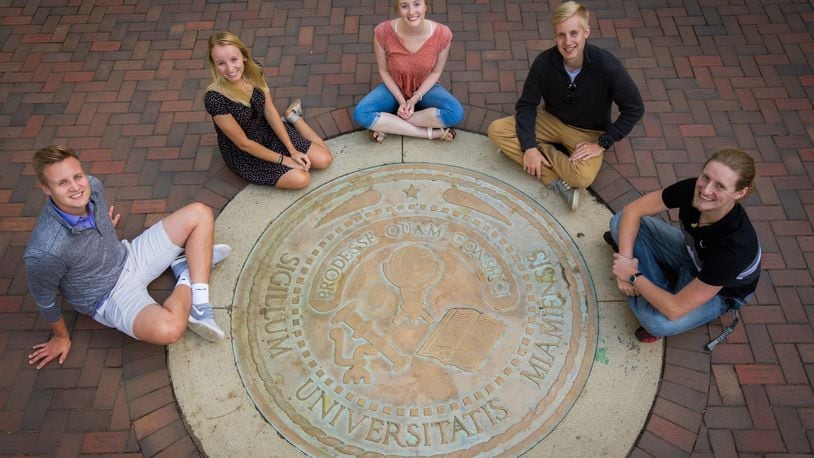 The Ridge siblings gather around Miami University’s famous seal on the Oxford campus of the school. The five are a rarity at Miami, with all of them taking undergraduate or graduate classes from the Butler County university. CONTRIBUTED
