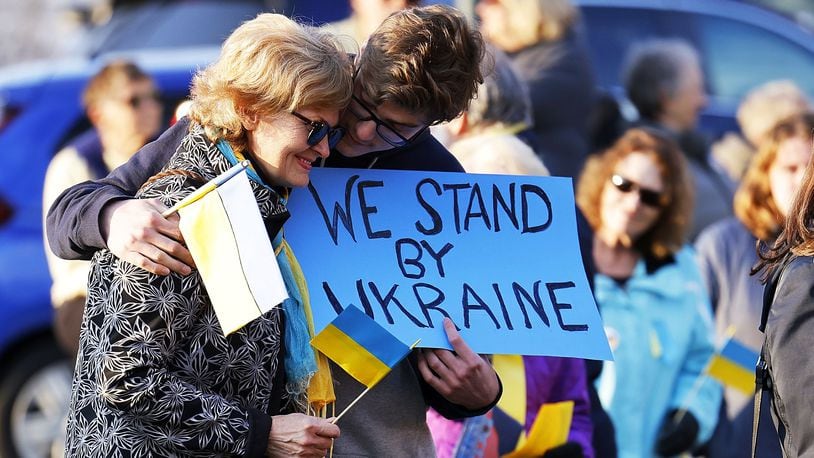 Angela Trubceac and her son, Darius Trubceac, 17, Oxford residents born in Moldova, a country that borders Ukraine, participate in a rally hosted by Oxford Citizens for Peace and Justice hosted in support of Ukraine with nearly 100 people in attendance Thursday, March 10, 2022 at Oxford Memorial Park.  NICK GRAHAM/STAFF