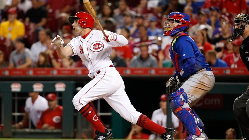 Cincinnati Reds’ Jose Peraza watches a two-run ground-rule double off Chicago Cubs relief pitcher Pedro Strop during the eighth inning of a baseball game, Thursday, Aug. 24, 2017, in Cincinnati. The Reds won 4-2. (AP Photo/John Minchillo)