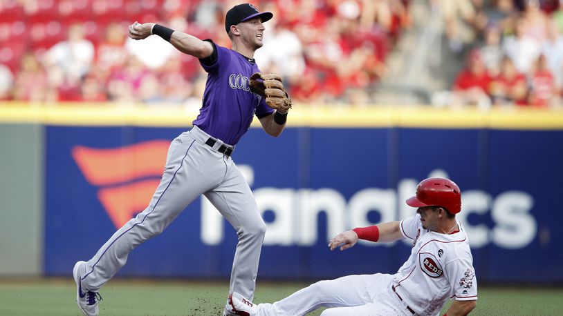 CINCINNATI, OH - JULY 26: Ryan McMahon #24 of the Colorado Rockies turns a double play ahead of the sliding Scooter Gennett #3 of the Cincinnati Reds in the second inning at Great American Ball Park on July 26, 2019 in Cincinnati, Ohio. (Photo by Joe Robbins/Getty Images)