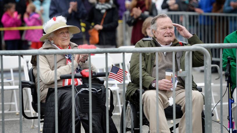 Former first lady Barbara Bush claps and former president George H. W. Bush salutes as the Memorial Day Parade in Kennebunkport goes by Monday, May 29, 2017. (Staff photo by Shawn Patrick Ouellette/Portland Press Herald via Getty Images)