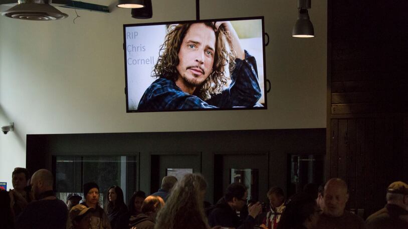 A portrait of Chris Cornell is seen on a screen during a memorial  in Seattle, Washington. Musician Chris Cornell, a member of revered rock groups Soundgarden and Audioslave, was found dead overnight in Detroit at age 52.  (Photo by David Ryder/Getty Images)