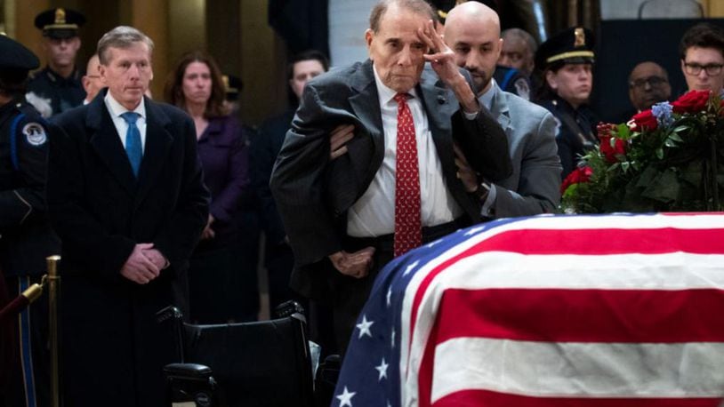Former Senator Bob Dole stands up and salutes the casket of the late former President George H.W. Bush as he lies in state at the U.S. Capitol, December 4, 2018 in Washington, DC. A WWII combat veteran, Bush served as a member of Congress from Texas, ambassador to the United Nations, director of the CIA, vice president and 41st president of the United States. Bush will lie in state in the U.S. Capitol Rotunda until Wednesday morning.