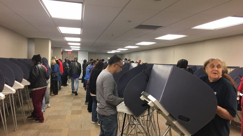 Early voters cast their ballots on electronic voting machines at the Montgomery County Board of Elections in 2016. Ohio counties are looking to replace voting machines, and those who now use touchscreen equipment could switch to optical scan paper ballots. LYNN HULSEY/STAFF
