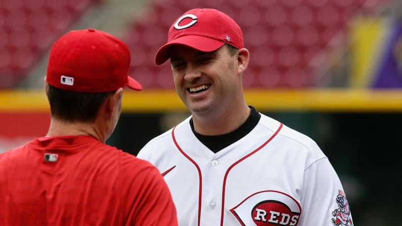 Bengals coach Zac Taylor, right, meets Reds manager David Bell for the first time on Opening Day on April 12, 2022, at Great American Ball Park in Cincinnati. David Jablonski/Staff