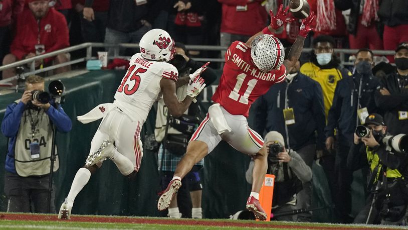 Ohio State wide receiver Jaxon Smith-Njigba (11) catches a touchdown in front of Utah cornerback Malone Mataele (15) during the second half in the Rose Bowl NCAA college football game Saturday, Jan. 1, 2022, in Pasadena, Calif. (AP Photo/Mark J. Terrill)