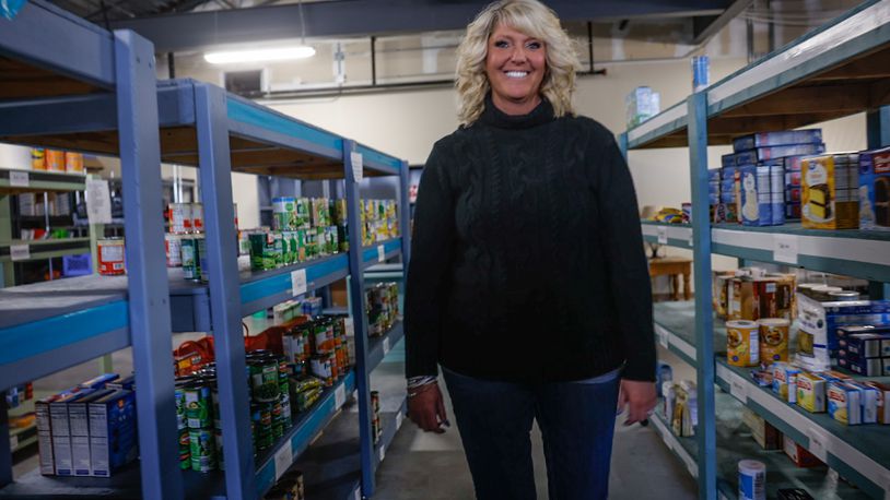 Springboro Community Assistance Center Director, Wendy Grothjan stands in the schools' large food pantry for students and families. FILE PHOTO