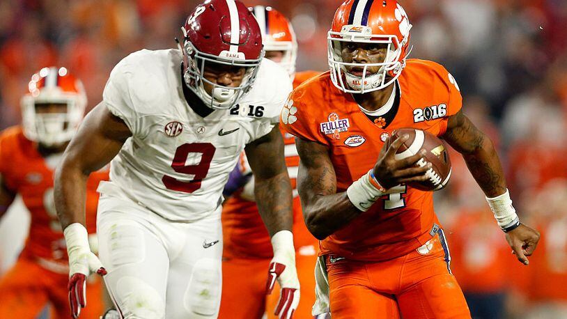 GLENDALE, AZ - JANUARY 11:  Deshaun Watson #4 of the Clemson Tigers runs the ball in the third quarter against Da'Shawn Hand #9 of the Alabama Crimson Tide during the 2016 College Football Playoff National Championship Game at University of Phoenix Stadium on January 11, 2016 in Glendale, Arizona.  (Photo by Christian Petersen/Getty Images)