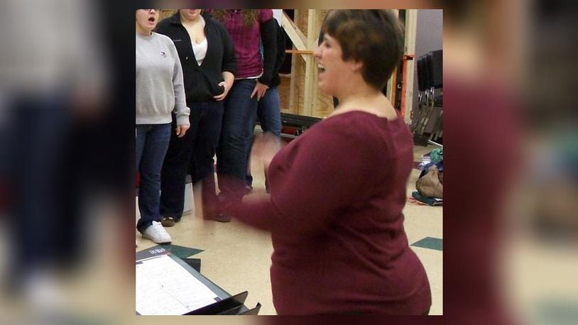 Former Lebanon City Schools teacher and high-school choir director Kristi L. Ross, 36, of Centerville has been indicted on a felony theft charge as well as misdemeanor counts of misuse of credit cards, tampering with records and falsification. She is pictured directing a district choir.