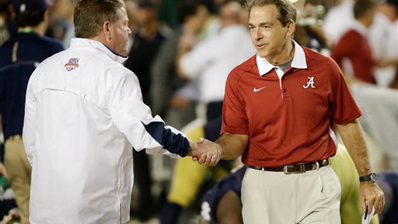 Notre Dame head coach Brian Kelly, left, shakes hands with Alabama head coach Nick Saban before the BCS National Championship college football game Monday, Jan. 7, 2013, in Miami. (AP Photo/David J. Phillip)