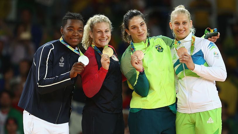 RIO DE JANEIRO, BRAZIL - AUGUST 11: Silver medalist Audrey Tcheumeo of France, gold medalist Kayla Harrison of the United States and bronze medalists Mayra Aguiar of Brazil and Anamari Velensek of Slovenia celebrate on the podium after the women’s -78kg judo contest on Day 6 of the 2016 Rio Olympics at Carioca Arena 2 on August 11, 2016 in Rio de Janeiro, Brazil. (Photo by Julian Finney/Getty Images)