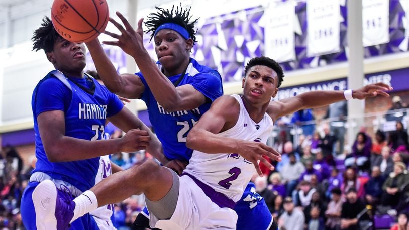 Middletown’s Shandon Morris (2) and Hamilton’s D’Marco Howard (25) and Romello Diablo (23) battle for a rebound during their game Dec. 7 at Wade E. Miller Arena in Middletown. The host Middies won 64-56. NICK GRAHAM/STAFF