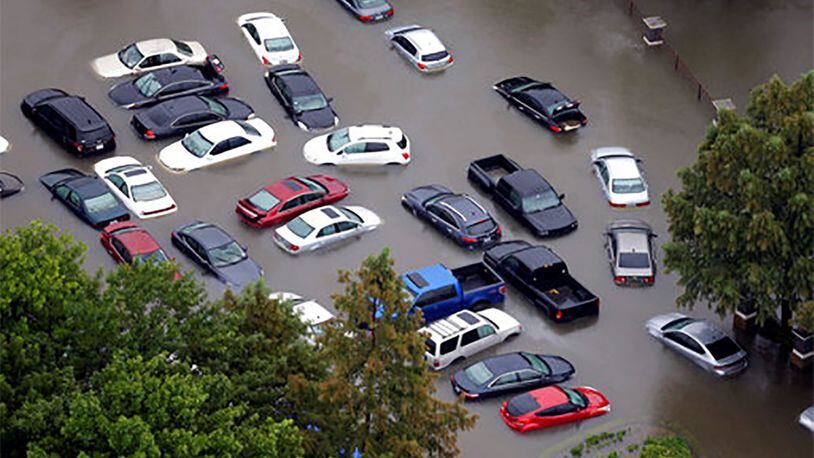 This Aug. 29 photo shows flooded cars near the Addicks Reservoir as floodwaters from Harvey rise in Houston. Auto industry experts estimate that 500,000 to 1 million cars, trucks and SUVs were damaged by floodwaters from Hurricane Harvey. Most will have so much water damage that they can t be fixed, and insurance companies will declare them total losses. Yet the damaged cars could be retitled and sold to unsuspecting buyers nationwide. Experts warn against buying the cars because damage could be hidden for years before causing problems. (AP Photo/David J. Phillip)