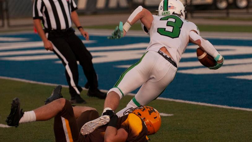 Badin receiver Lucas Moore is stopped at the 1-yard line by Alter's Mike Lantz at the end of a 39-yard catch to set up the Rams' first touchdown in Friday night's 14-12 victory over Alter at Roush Stadium. Jeff Gilbert/CONTRIBUTED