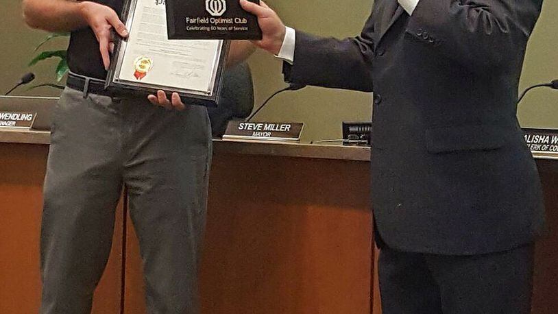 Jeff Herold, president of the Fairfield Optimist Club, accepts honors bestowed on the club in celebration of its 60th anniversary from Fairfield Mayor Steve Miller at the Sept. 12, 2016, city council meeting.