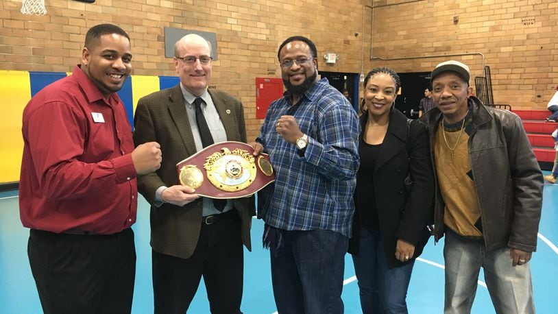 Pictured (from left): Samy Broyles of the BTW Center; Hamilton Mayor Pat Moeller holding the heavyweight boxing title belt; former heavyweight boxing champion Lamon Brewster; Brewster’s wife, Juana; and Alonzo Wells, a Hamilton resident who arranged Brewster’s local visit. WAYNE BAKER/STAFF