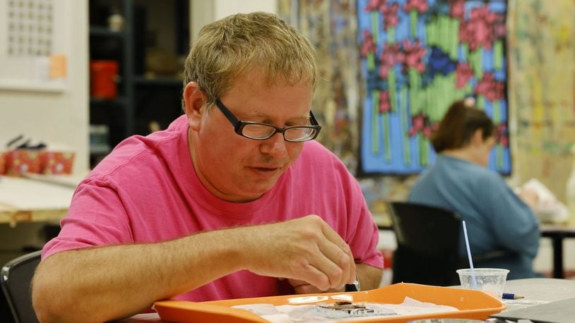 David Campbell works on an art glass project in late June at InsideOut Studio in Hamilton. NICK GRAHAM/STAFF