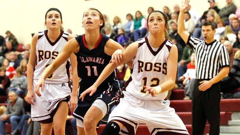 Talawanda’s Ana Richter (11) and Ross’ Hayley Hudson (12) fight for position after a free throw at RHS on Jan. 8, 2014. The Braves won 70-51. NICK DAGGY/STAFF