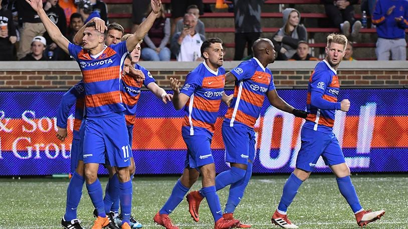 FC Cincinnati forward Danni Konig (11) raised his arms as he is congratulated by teammates after scoring against Pittsburgh Riverhounds in the second half at Nippert stadium. FC Cincinnati battled to a 2 all tie game against the Pittsburgh Riverhounds. Photo by Joseph Fuqua II for WCPO