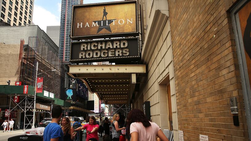 People, many who have been there for days, wait in line with dozens of others for tickets for the popular Broadway show Hamilton on June 21, 2016 in New York City. The Tony Award-winning Broadway hit has drawn huge crowds to the Richard Rogers theater in tin he hopes of getting increasingly scarce and expensive tickets. Carrying bed rolls, pillows and take-out food containers, many fans of the musical wait days in the heat and rain for a chance to get a cancellation ticket which are offered to the public once they're declined by members of the cast and crew.  (Photo by Spencer Platt/Getty Images)