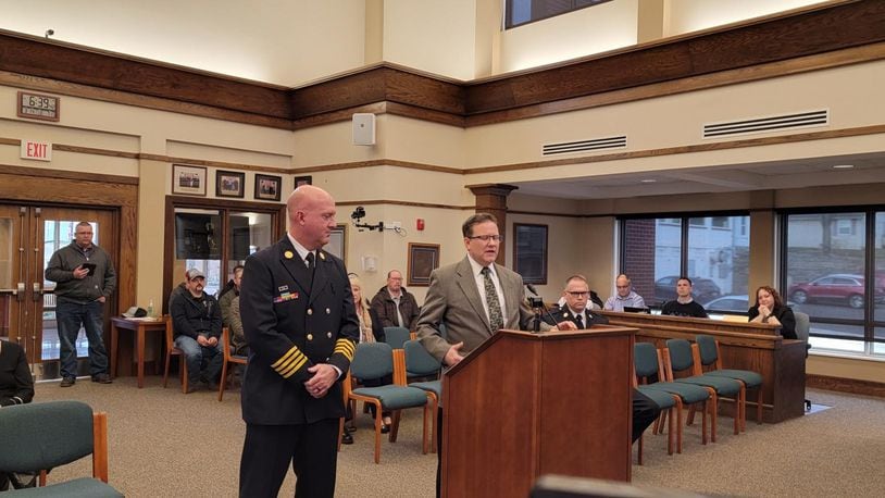 Monroe City Manager Bill Brock, right, talks about Dave Leverage, who was appointed fire chief during Tuesday's City Council meeting. Leverage replaced retiring Fire Chief John Centers. SUBMITTED PHOTO
