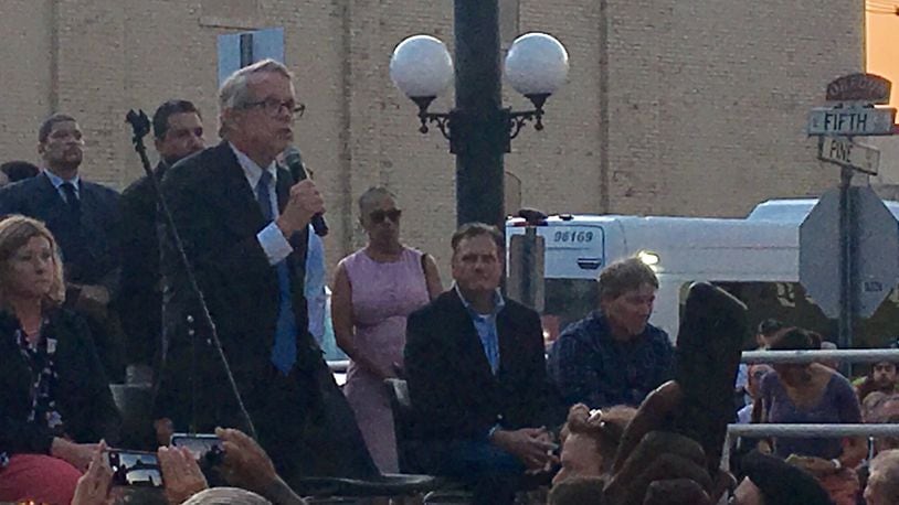 Gov. Mike DeWine speaks at a vigil for victims and survivors of the August 2019 shooting in Dayton’s Oregon District. The governor was met with shouts of “Do something” from the crowd, amid frustration over continuing mass shootings.