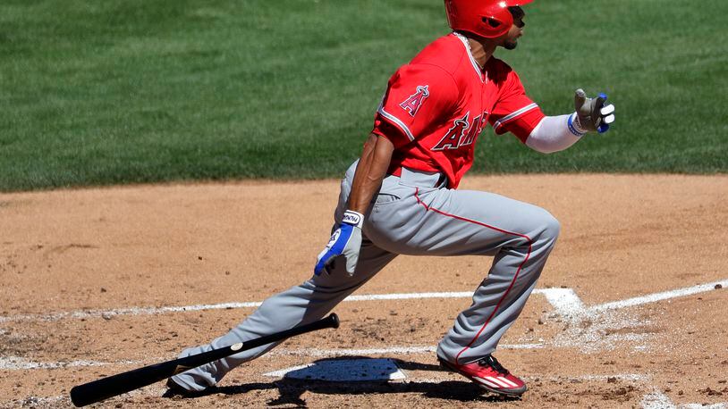 FILE - In this March 11, 2017, file photo, Los Angeles Angels’ Ben Revere follows through on an RBI base hit against the Los Angeles Dodgers during the third inning of a spring training baseball game, in Phoenix. Revere signed a minor-league deal with the Reds, Monday, Feb. 26, 2018, who need depth in the outfield and an upgrade on the bench. (AP Photo/Matt York, File)