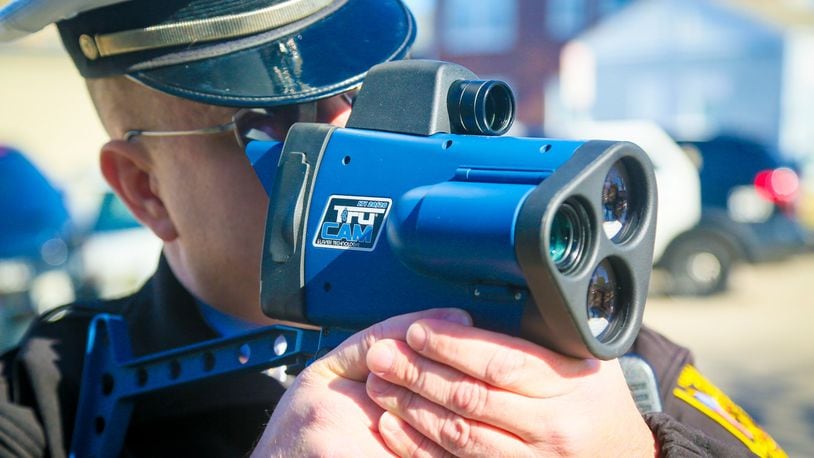 Hamilton police department traffic officer Michael Coleman demonstrates one of their new Laser Technologies LTI20/20 Trucam hand held laser speed measuring devices, Monday, Feb. 13, 2017. The new devices can record video and still photographs. GREG LYNCH / STAFF