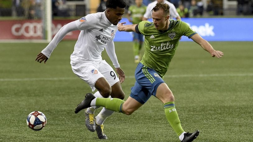 SEATTLE, WA - MARCH 02: Alvas Powell #92 of FC Cincinnati tries to get past Brad Smith #11 of the Seattle Sounders battle for a ball during the first half ot the match at CenturyLink Field on March 2, 2019 in Seattle, Washington. (Photo by Steve Dykes/Getty Images)
