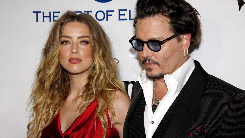 Amber Heard and Johnny Depp at the Art Of Elysium's Ninth Annual Heaven Gala, held at the 3LABS on Jan. 9, 2016 in Culver City, Calif. Depp and Heard have settled their divorce battle and will avoid a court hearing. (Lumeimages/Sipa USA/TNS)
