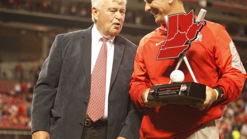 Reds Chief Executive Officer Bob Castellini, left, talks to Ohio State coach Urban Meyer after presenting him with the Reds Country Athletic Achievement Award before a game at Great American Ball Park on Wednesday, April 8, 2015, in Cincinnati. David Jablonski/Staff