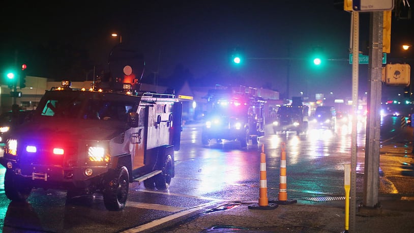 FERGUSON, MO - AUGUST 15:  A convoy of armored personnel carriers (APC) carrying county police arrive after Missouri State Highway Patrol officers were taunted by demonstrators during a protest over the shooting of Michael Brown on August 15, 2014 in Ferguson, Missouri. As the taunts became more aggressive the troopers called in the county police then left the area. County police ended up shooting pepper spray, smoke, gas and flash grenades at protestors before retreating. Several businesses were looted as the county police watched from their APC parked nearby. Violent outbreaks have taken place in Ferguson since the shooting death of Brown by a Ferguson police officer on August 9.  (Photo by Scott Olson/Getty Images)