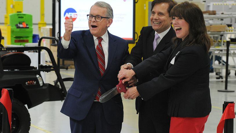 At the re-dedication event for American Battery Solutions in Springboro, From left, Ohio Governor, Mike DeWine, Founder, Chairman & CEO, Subhash Dhar and Springboro City Council member Becky Iverson are all smiles during the ribbon cutting Monday April 4, 2022. MARSHALL GORBY\STAFF