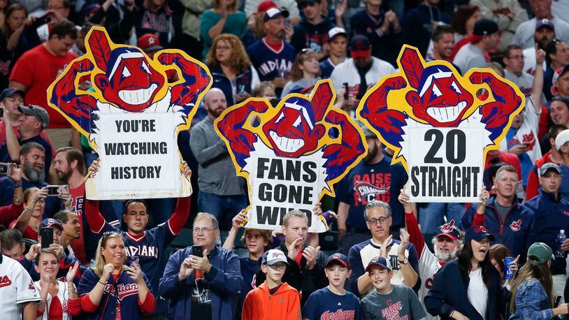 Cleveland Indians fans celebrate a 2-0 victory over the Detroit Tigers in a baseball game, Tuesday, Sept. 12, 2017, in Cleveland. The Indians won their 20th game in a row, tying the American League record. (AP Photo/Ron Schwane)