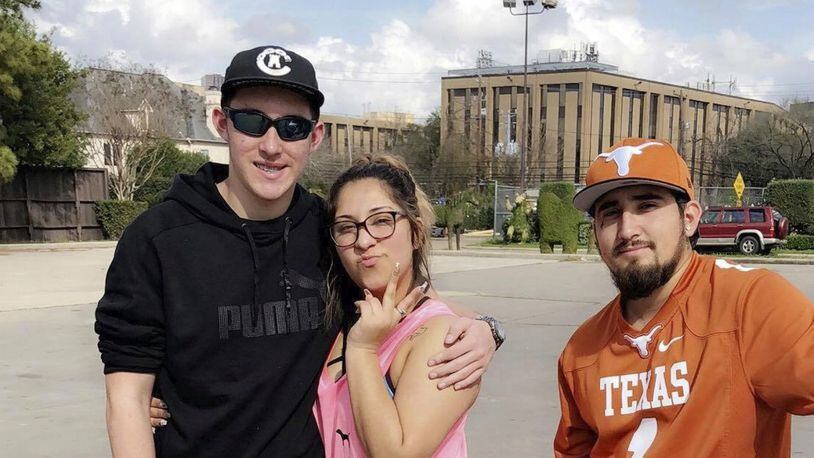 In this Feb. 18, 2018, photo provided by Ashley Fonseca, her cousin Christopher Riley Garcia, left, poses for a picture with Ashley and Robert Zamora in Houston. A gunman opened fire at Santa Fe High School on Friday, May 18, 2018, killing 10 people, including Garcia, in Santa Fe, Texas.