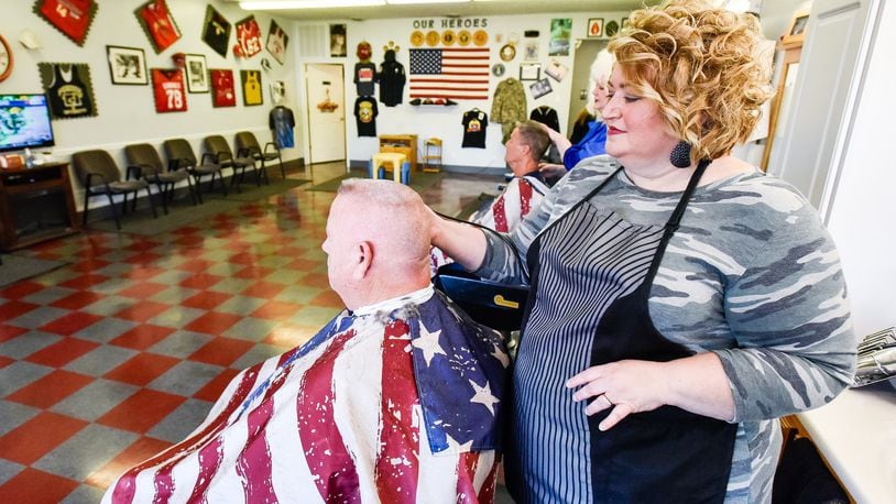 Terra Combs cuts Ken Campbell’s hair at Dixie chicks Barber Shop Tuesday, Oct. 15 on Pleasant Avenue in Fairfield. Combs has purchased Dixie Chicks Barber Shop after working there for several years. NICK GRAHAM/STAFF
