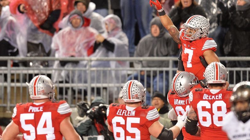 COLUMBUS, OH - NOVEMBER 21:  Jalin Marshall #7 of the Ohio State Buckeyes celebrates after catching a six-yard touchdown pass in the third quarter against the Michigan State Spartans at Ohio Stadium on November 21, 2015 in Columbus, Ohio. Michigan State defeated Ohio State 17-14.  (Photo by Jamie Sabau/Getty Images)