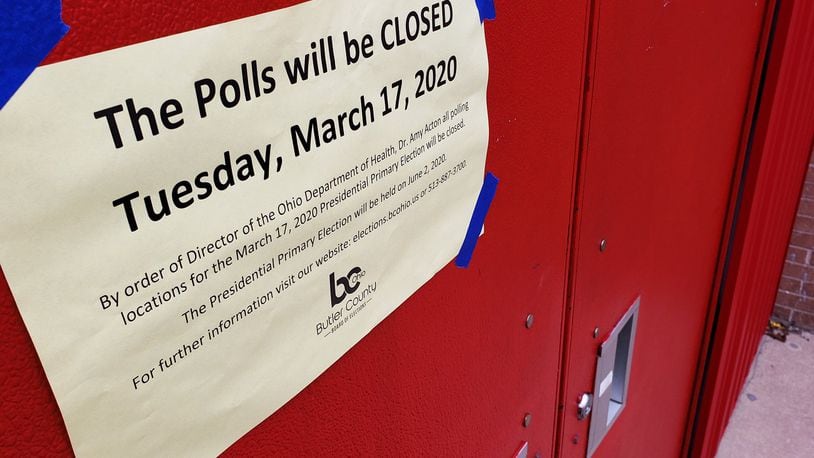 A sign posted on Madison High School on Tuesday, March 17, 2020, indicated in-person voting was delayed. Ohio Secretary of State Frank LaRose is pushing for in-person voting for the presidential primary, which is now scheduled for June 2. NICK GRAHAM/STAFF
