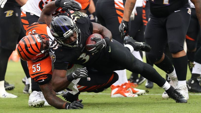 BALTIMORE, MD - NOVEMBER 18: Running Back Gus Edwards #35 of the Baltimore Ravens runs with the ball as he is tackled by outside linebacker Vontaze Burfict #55 of the Cincinnati Bengals in the second quarter at M&T Bank Stadium on November 18, 2018 in Baltimore, Maryland. (Photo by Patrick Smith/Getty Images)
