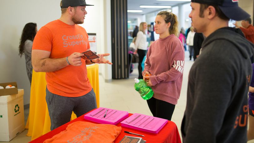 Trainers from CrossFit Superfly answer questions about functional fitness during a vendor fair at Countryside YMCA. CONTRIBUTED