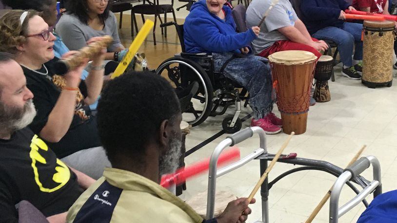 Several residents participate in the drum circle that was held in Hamilton last week. The Initiative was created by Josh Trumbull, a Miami University Regionals student and youth pastor.